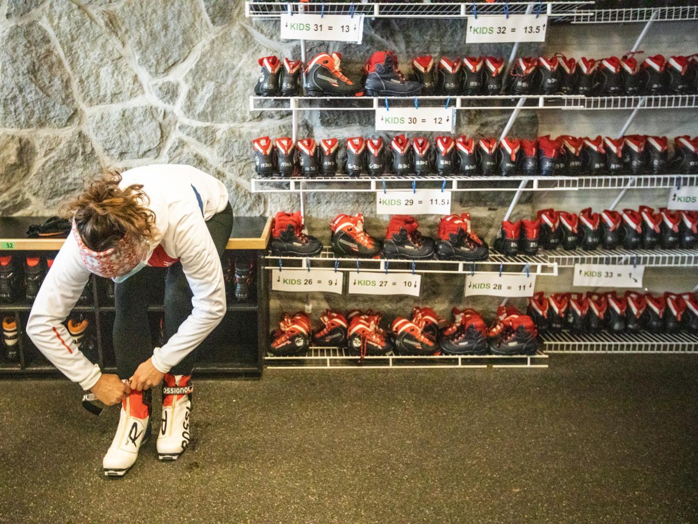 Woman putting on equipment in rental shop