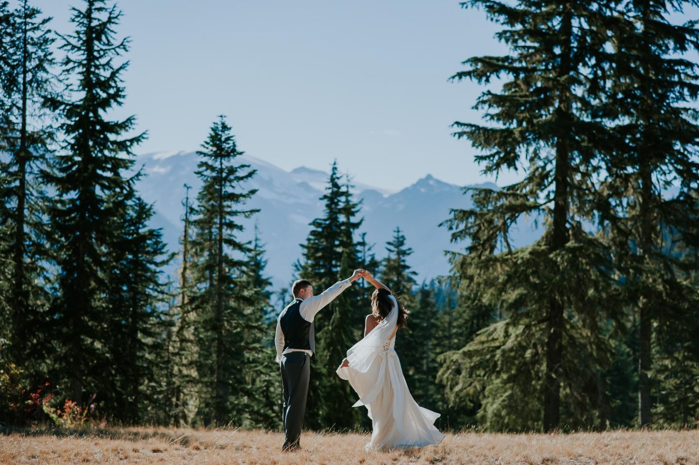bride and groom dancing in forest