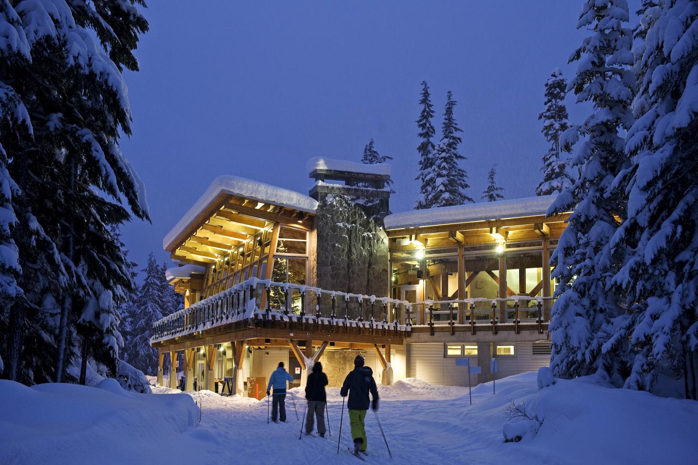 Day lodge at night with skiers