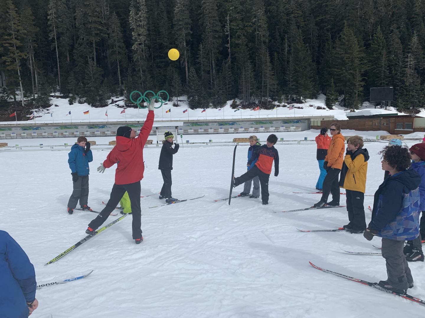 kids playing with ball on skis in winter time