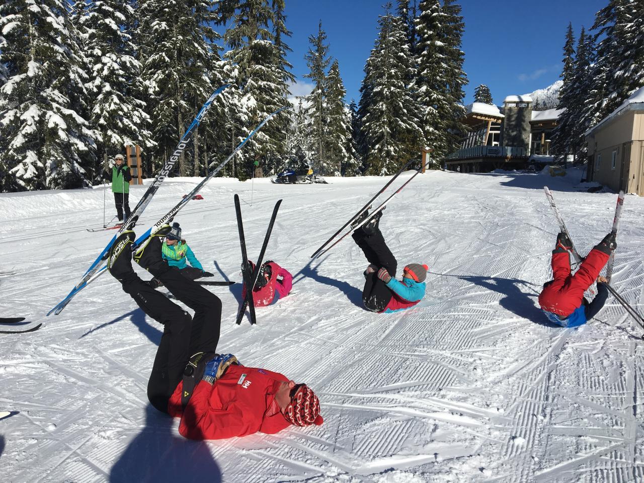 kids holding up skis in air