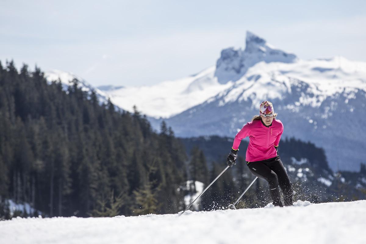 Woman skiing with mountains in background