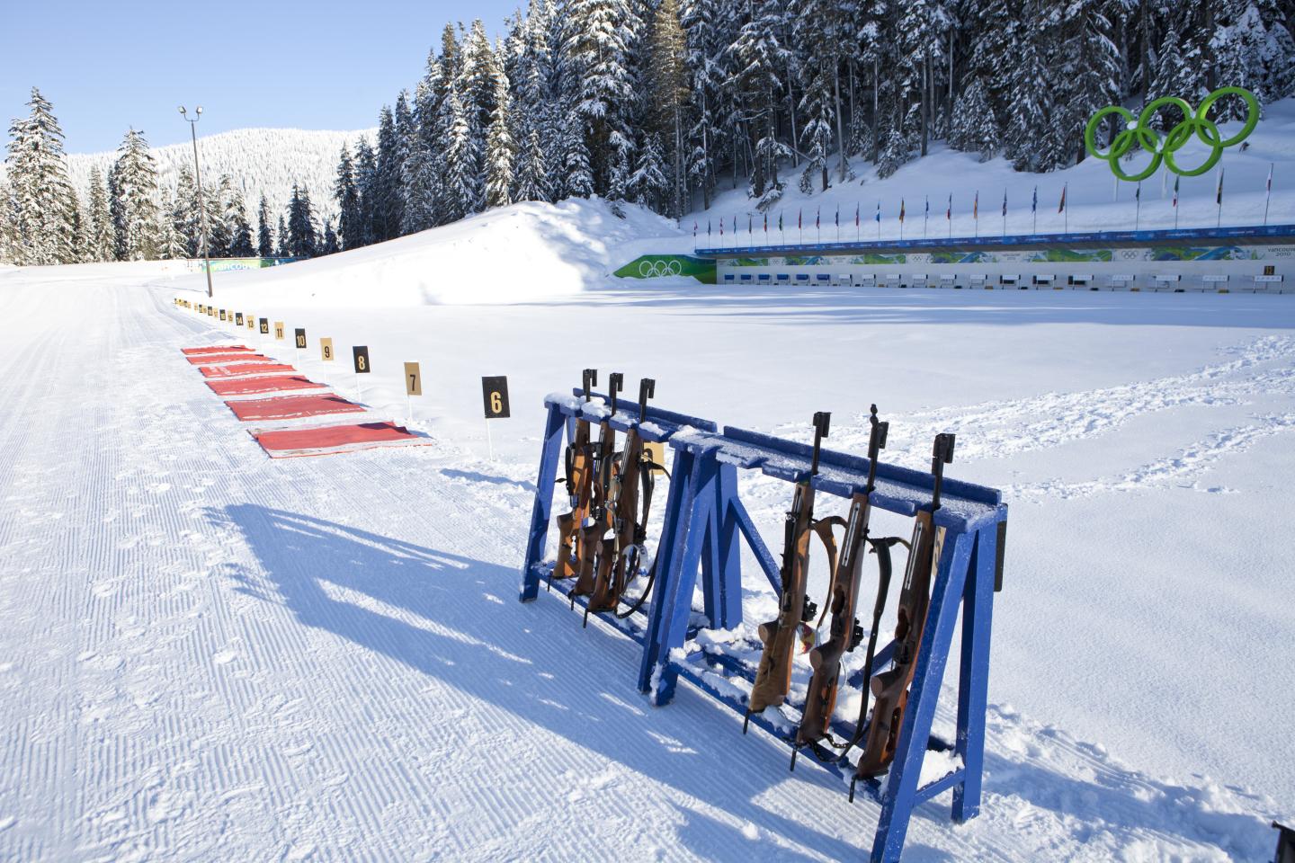 biathlon range setup with guns lined up on rack