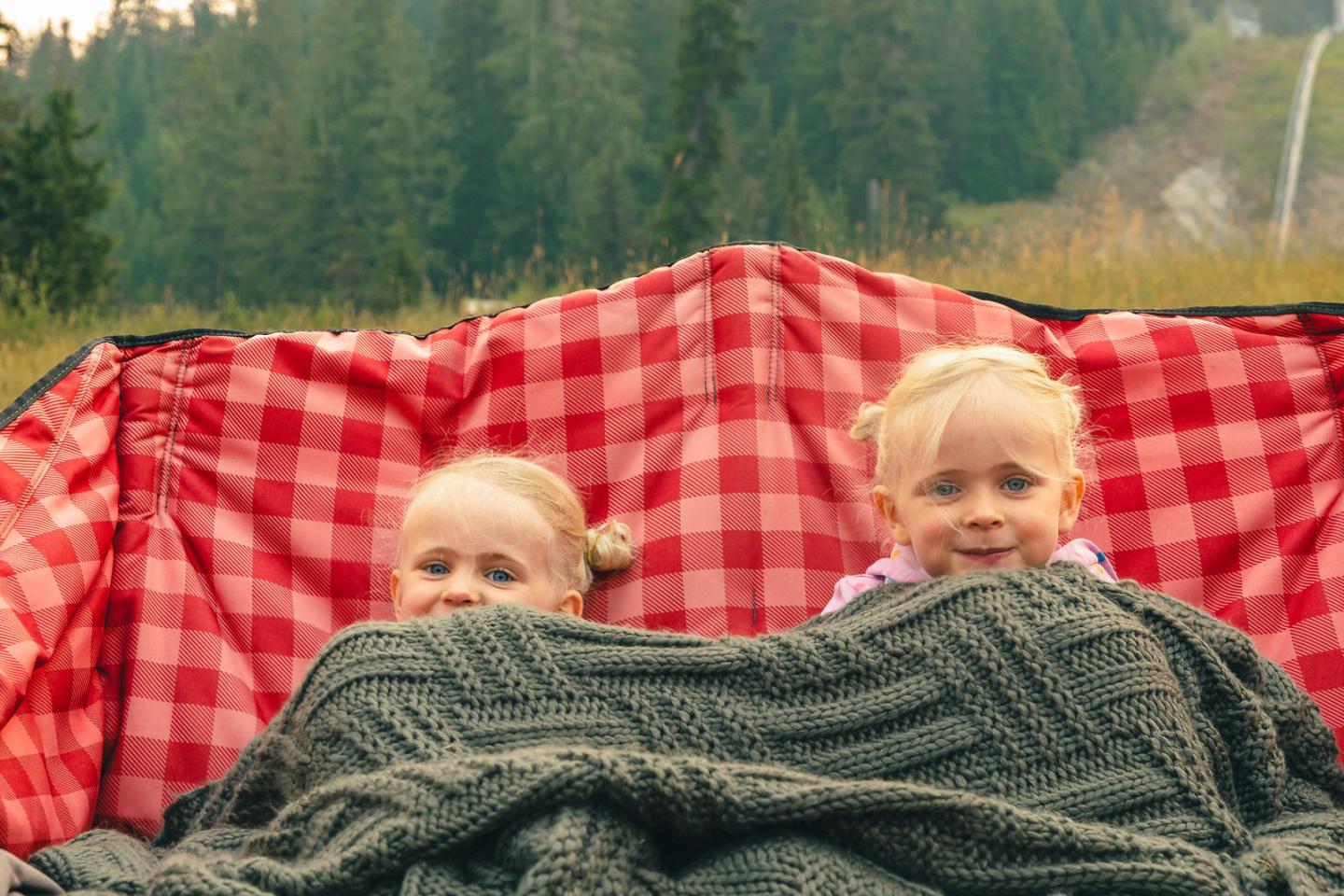 2 girls with blanket camping