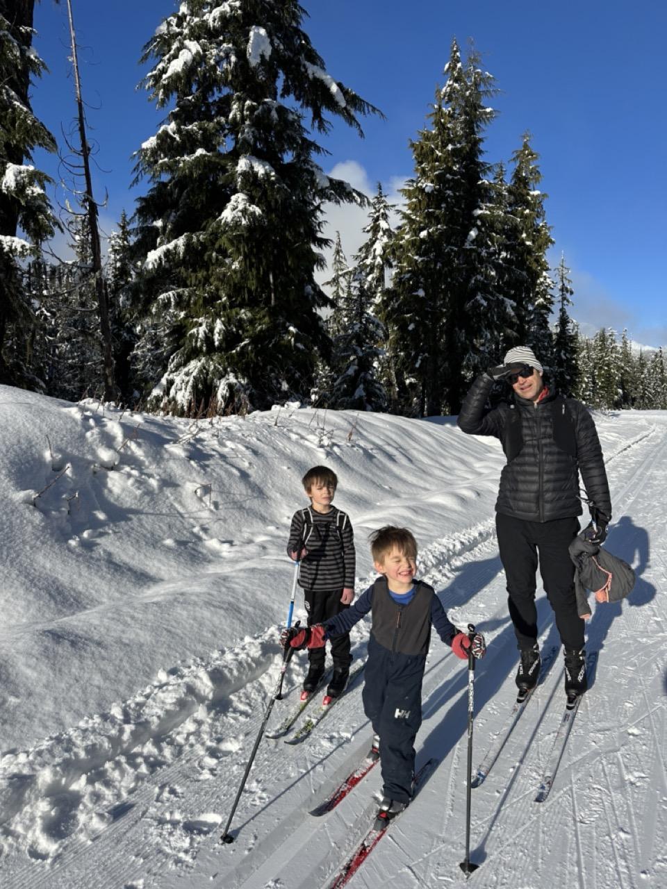 Dad and kids skiing the sunshine loop at Whistler Olympic Park