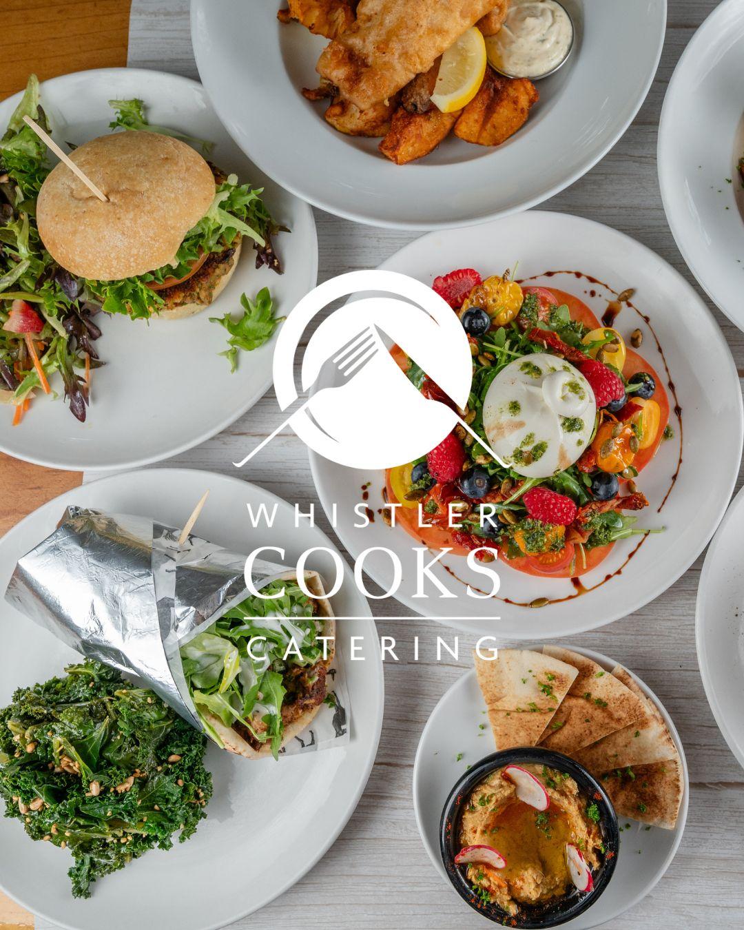 Assorted dishes on a table, including a burger, salad. Whistler Olympic Parc Cafe by Whistler Cooks