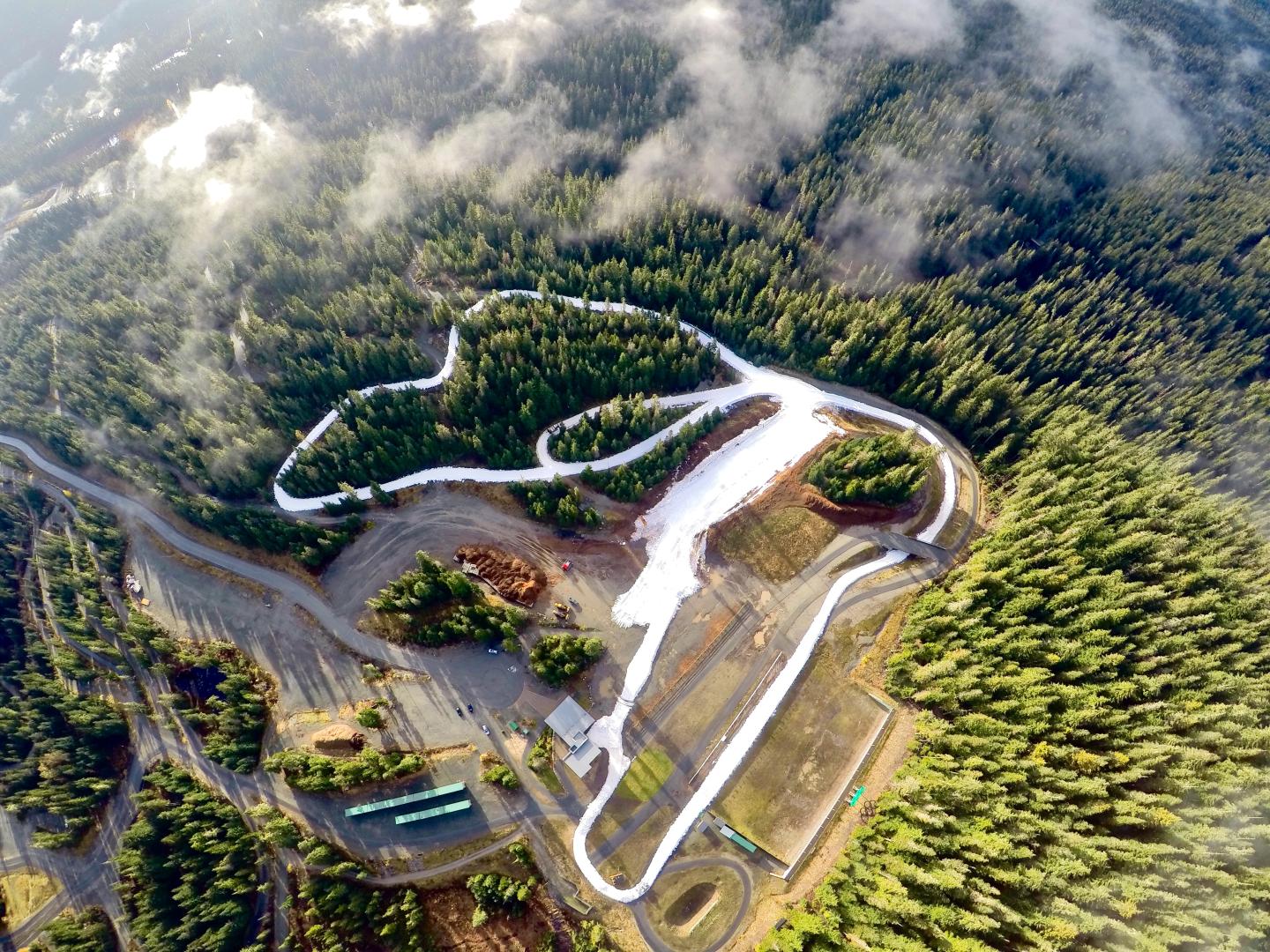 Aerial view of a winding road through a forested landscape. Callaghan Gold at Whistler Olympic Park
