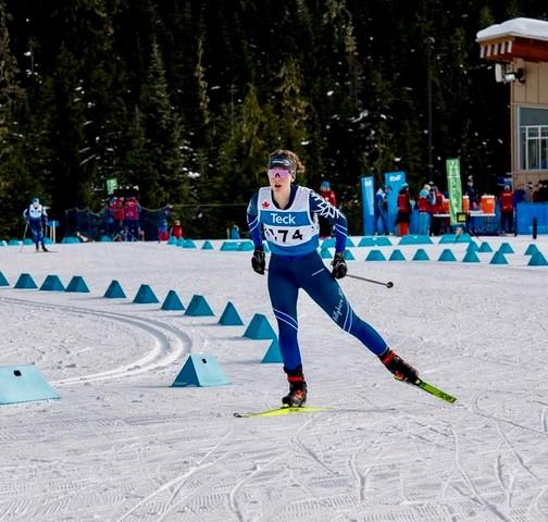 Rowan Brecher Cross-country skier racing on snow with trees in the background.